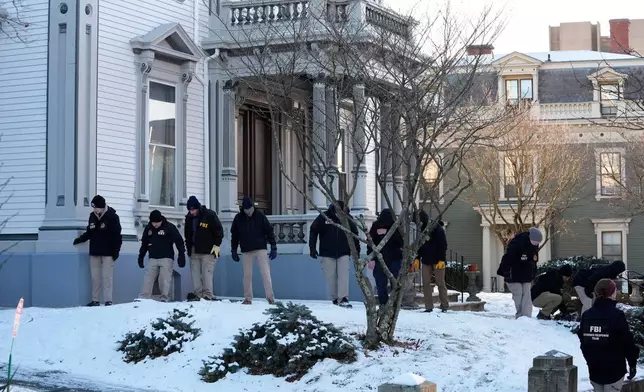 Members of the FBI Evidence Response Team search for evidence near the campus of Brown University, Monday, Dec. 15, 2025, in Providence, R.I. (AP Photo/Robert F. Bukaty)