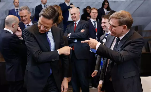 Germany's Foreign Minister Johann Wadephul, right, speaks with NATO Secretary General Mark Rutte during a meeting of the North Atlantic Council in Foreign Ministers Session at NATO headquarters in Brussels, Wednesday, Dec. 3, 2025. (AP Photo/Geert Vanden Wijngaert)