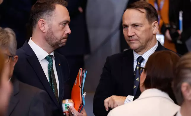 Belgium's Foreign Minister Maxime Prevot, left, speaks with Poland's Foreign Minister Radoslaw Sikorski during a meeting of the North Atlantic Council in Foreign Ministers Session at NATO headquarters in Brussels, Wednesday, Dec. 3, 2025. (AP Photo/Geert Vanden Wijngaert)