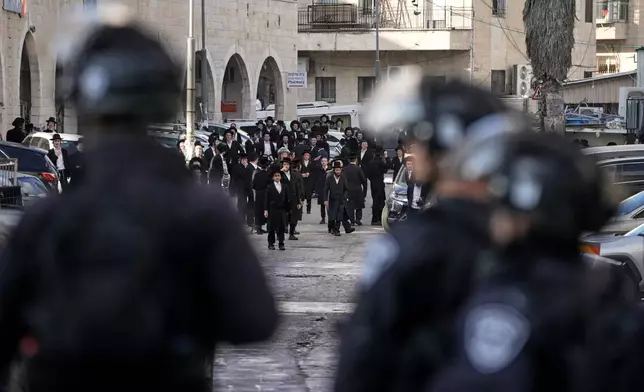 Ultra Orthodox protesters clash with Israeli police during a violent disturbance in Jerusalem, Thursday, Dec. 18, 2025. (AP Photo/ Mahmoud Illean)