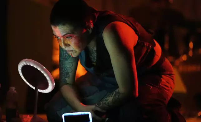 Mexican composer Maria Leonora performs her series she calls “Through All the Fire,” at the Sergio Magaña Theater in Mexico City, Friday, Nov. 28, 2025. (AP Photo/Claudia Rosel)