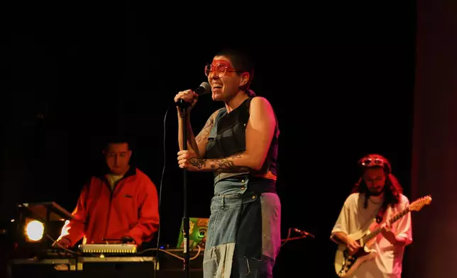 Mexican composer Maria Leonora performs her series she calls “Through All the Fire,” at the Sergio Magaña Theater in Mexico City, Friday, Nov. 28, 2025. (AP Photo/Claudia Rosel)