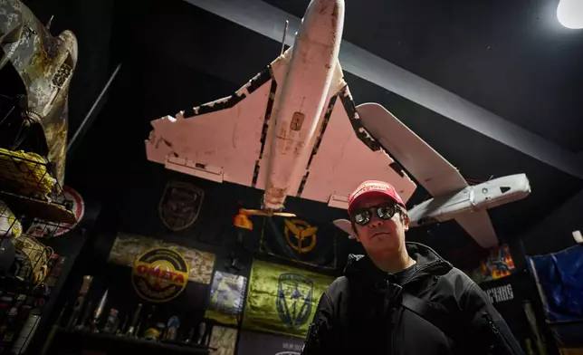 Ukrainian street artist Maxim Kilderov stands amid a collection of battlefield artifacts documenting Russia's invasion of Ukraine in his private museum in Kyiv, Ukraine, Friday, Dec. 12, 2025. (AP Photo/Efrem Lukatsky)