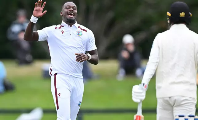 West Indies bowler Jayden Seales, left, celebrates the wicket of New Zealand's Zak Foulkes during during their cricket test match in Christchurch, New Zealand, Wednesday, Dec. 3, 2025. (Andrew Cornaga/Photosport via AP)