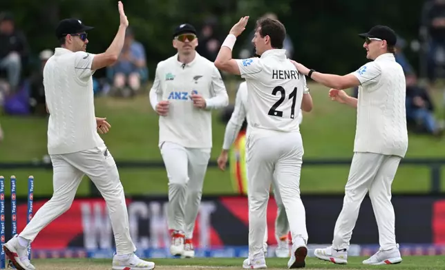 New Zealand bowler Matt Henry, second right, celebrates with teammates after taking the wicket of the West Indies' Alick Athanaze during their cricket test match in Christchurch, New Zealand, Wednesday, Dec. 3, 2025. (Andrew Cornaga/Photosport via AP)