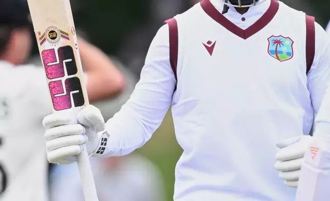 West Indies' batsman Shai Hope raises his bat after making 50 runs against New Zealand during the second day of their cricket test match in Christchurch, New Zealand, Wednesday, Dec. 3, 2025. (Andrew Cornaga/Photosport via AP)
