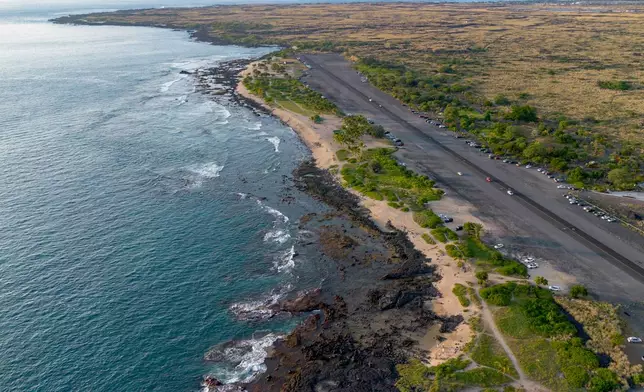 A drone photo shows the shoreline near the Old Kona Airport area, where local groups manage colonies of stray cats, Tuesday, Dec. 2, 2025, in Kailua-Kona, Hawaii. (AP Photo/Mengshin Lin)