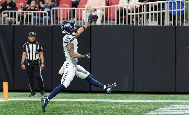 Seattle Seahawks wide receiver Jaxon Smith-Njigba reacts after scoring a touchdown against the Atlanta Falcons during the second half of an NFL football game, Sunday, Dec. 7, 2025, in Atlanta. (AP Photo/Brynn Anderson)