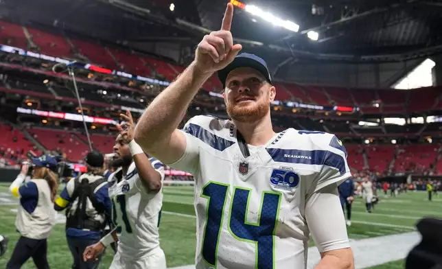 Seattle Seahawks quarterback Sam Darnold points to fans after a victory over the Atlanta Falcons in an NFL football game, Sunday, Dec. 7, 2025, in Atlanta. (AP Photo/Brynn Anderson)