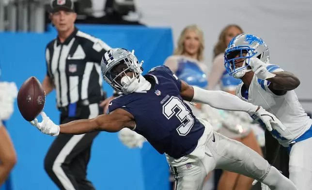 Dallas Cowboys wide receiver George Pickens (3) reaches but is unable to pull a catch as Detroit Lions cornerback D.J. Reed defends during the first half of an NFL football game Thursday, Dec. 4, 2025, in Detroit. (AP Photo/Paul Sancya)