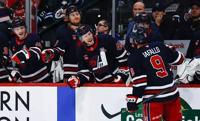 Winnipeg Jets' Alex Iafallo (9) celebrates his goal against the Washington Capitals during the second period of an NHL game in Winnipeg on Saturday, Dec. 13, 2025. (John Woods/The Canadian Press via AP)