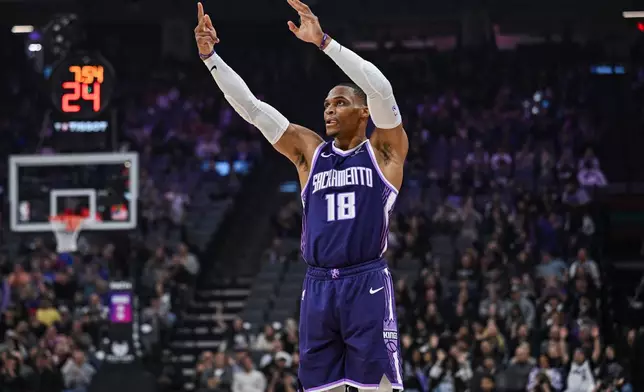 Sacramento Kings guard Russell Westbrook reacts after a 3-point basket during the first half an NBA basketball game against the Houston Rockets, Sunday, Dec. 21, 2025, in Sacramento, Calif. (AP Photo/Justine Willard)