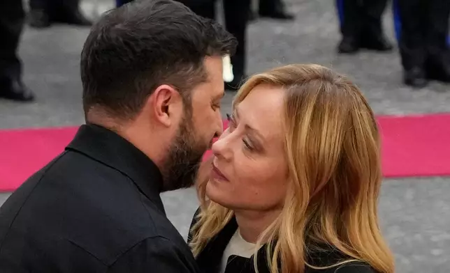 Ukraine's President Volodymyr Zelenskyy, left, is received at Chigi Palace by Italian Premier Giorgia Meloni, Tuesday, Dec. 9, 2025. (AP Photo/Gregorio Borgia)