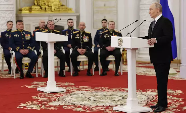 Russian President Vladimir Putin speaks prior to the awarding ceremony for Russian heroes, military and civilian, marking Heroes of the Fatherland Day at the Kremlin in Moscow, Tuesday, Dec. 9, 2025. (Gavriil Grigorov, Sputnik, Kremlin Pool Photo via AP)
