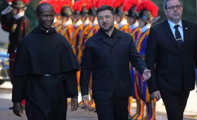Ukraine President Volodymyr Zelenskyy, center, arrives to meet with Pope Leo XIV in Castel Gandolfo, Italy, Tuesday, Dec. 9, 2025. (AP Photo/Andrew Medichini)