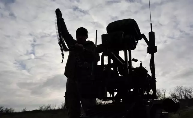 In this photo, provided by Ukraine's 65th Mechanized Brigade press service, a soldier tests land drones in Zaporizhzhia region, Ukraine, Saturday, Dec. 6, 2025, (Andriy Andriyenko/Ukraine's 65th Mechanized Brigade via AP)