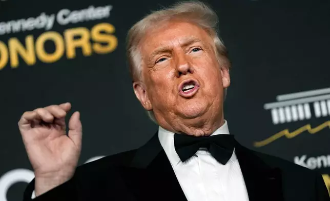 President Donald Trump talks to the media while walking the red carpet before the 48th Kennedy Center Honors, Sunday, Dec. 7, 2025, at the John F. Kennedy Center for the Performing Arts in Washington. (AP Photo/Julia Demaree Nikhinson)