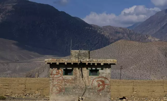 Communist graffiti is seen on the wall of a small building along a highway in Mustang district, Nepal, April 17, 2025. (AP Photo/Niranjan Shrestha)
