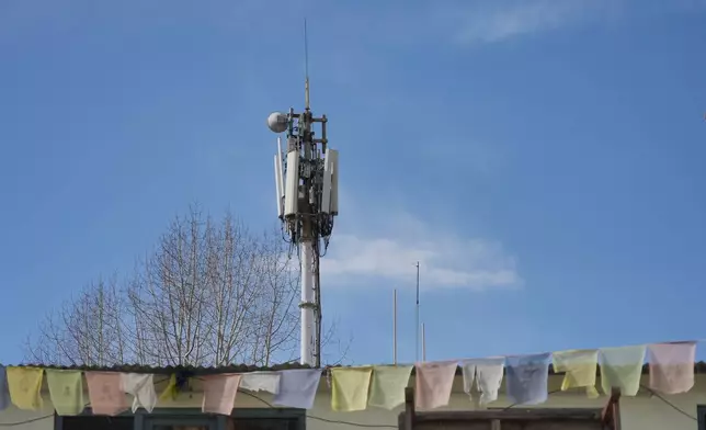 A Nepal Telecom cell tower wired with Chinese equipment stands near Sree Muktinath temple in the remote Himalayan town of Ranipauwa, Nepal, April 16, 2025. (AP Photo/Dake Kang)