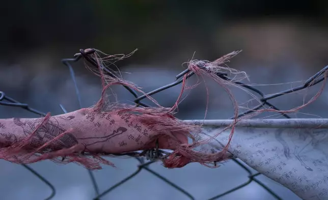 Torn Buddhist prayer flags are seen stuck on barbed wire that surrounds the Tibetan camp territory in Mustang, Nepal, April 19, 2025. (AP Photo/Niranjan Shrestha)