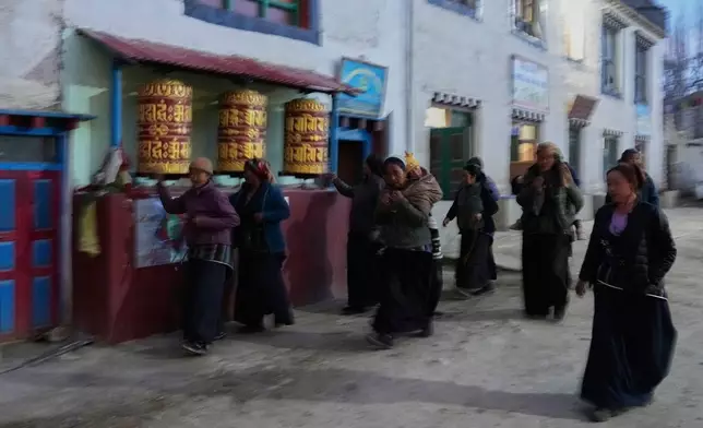 Nepalese Buddhist women walk back to their homes after an evening walk through monasteries in Lo Manthang village, Mustang, Nepal, April 18, 2025. (AP Photo/Niranjan Shrestha)