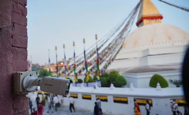 A Hikvision camera monitors crowds circling the Boudhanath, a holy Tibetan Buddhist stupa in Kathmandu, Nepal, April 20, 2025.(AP Photo/Dake Kang)