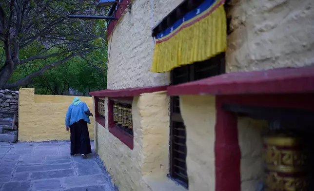 An elderly Tibetan exile walks near a monastery inside a Tibetan refugee camp in Mustang, Nepal, April 19, 2025. (AP Photo/Niranjan Shrestha)