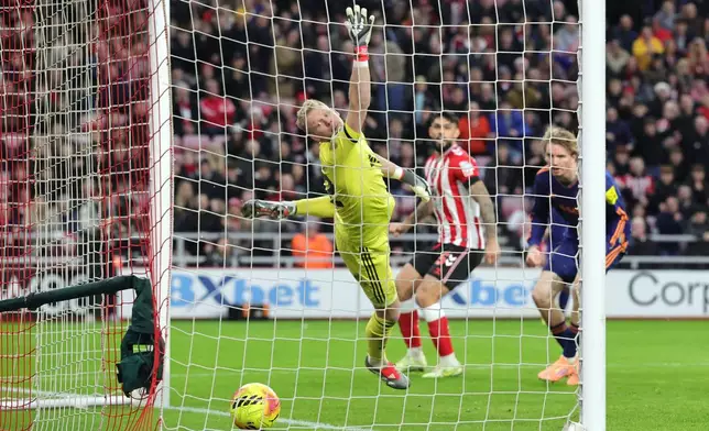 Newcastle United's Nick Woltemade scores Sunderland's first goal of the game, via an own goal during their English Premier League soccer match in Sunderland, England, Sunday, Dec. 14, 2025. (Steve Welsh/PA via AP)