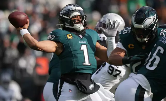 Philadelphia Eagles quarterback Jalen Hurts (1) throws during the first half of an NFL football game against the Las Vegas Raiders on Sunday, Dec. 14, 2025, in Philadelphia. (AP Photo/Matt Slocum)
