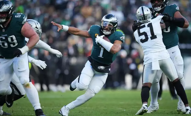 Philadelphia Eagles quarterback Jalen Hurts (1) runs with the ball during the second half of an NFL football game against the Las Vegas Raiders on Sunday, Dec. 14, 2025, in Philadelphia. (AP Photo/Matt Slocum)