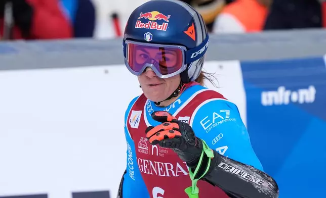 Italy's Sofia Goggia celebrates at the finish area of an alpine ski, women's World Cup super-G in Val d'Isere, France, Sunday, Dec. 21, 2025. (AP Photo/Giovanni Auletta)