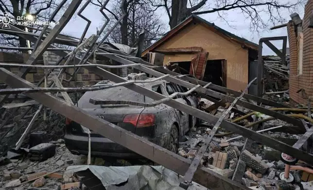 In this photo provided by the Ukrainian Emergency Service on Tuesday, Dec. 23, 2025, a residential house is seen damaged after a Russian strike in Zhytomyr region, Ukraine. (Ukrainian Emergency Service via AP)