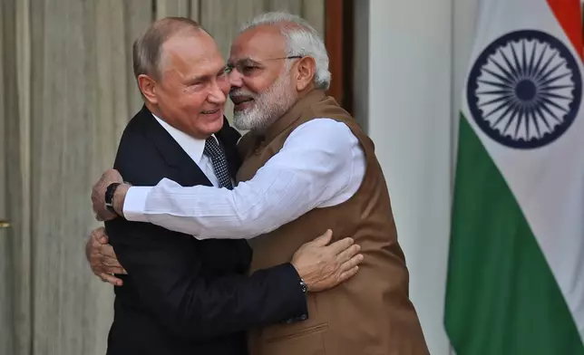FILE - Indian Prime Minister Narendra Modi, right, hugs Russian President Vladimir Putin before their meeting in New Delhi, India, on Oct. 5, 2018. (AP Photo/Manish Swarup, File)