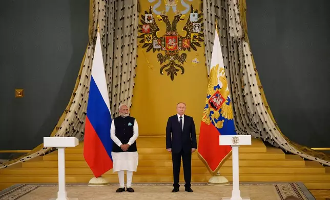 FILE - Indian Prime Minister Narendra Modi, left, and Russian President Vladimir Putin stand in a hall in the Kremlin in Moscow, Russia, on July 9, 2024. (AP Photo/Alexander Zemlianichenko, File)