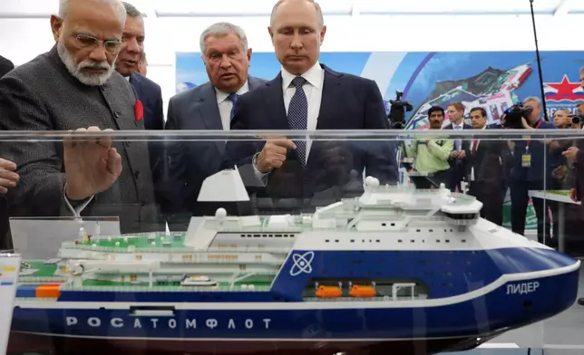 FILE - Russian President Vladimir Putin, right, and Indian Prime Minister Narendra Modi, left, look at a model of a Leader nuclear-powered icebreaker as they visit the Zvezda shipyard in the town of Bolshoi Kamen, Russia, on Sept. 4, 2019. (Mikhail Klimentyev, Sputnik, Kremlin Pool Photo via AP, File)