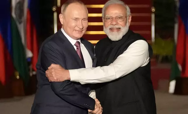FILE - Russian President Vladimir Putin, left, and Indian Prime Minister Narendra Modi greet each other before their meeting in New Delhi, India, on Dec. 6, 2021. (AP Photo/Manish Swarup, File)