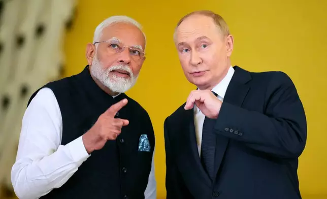 FILE - Russian President Vladimir Putin, right, and Indian Prime Minister Narendra Modi examine a hall prior to the award ceremony of Narendra Modi with the Order of St. Andrew the Apostle the First-Called in the Kremlin in Moscow, Russia, on July 9, 2024. (AP Photo/Alexander Zemlianichenko, File)