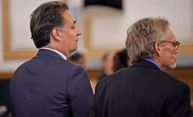 Brian Walshe, left, and lawyer Larry Tipton listen as the jury is polled about their guilty verdict of the first degree murder of his wife Ana in 2023 by a Norfolk Superior Court jury in Dedham, Mass., on Monday Dec. 15, 2025. (Greg Derr/The Patriot Ledger via AP, Pool)