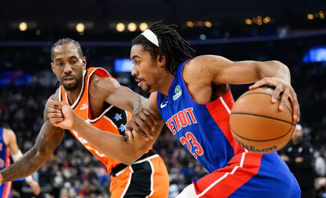 Detroit Pistons guard Jaden Ivey (23) drives the ball while under pressure from Los Angeles Clippers forward Kawhi Leonard during the first half of an NBA basketball game, Sunday, Dec. 28, 2025, in Inglewood, Calif. (AP Photo/William Liang)