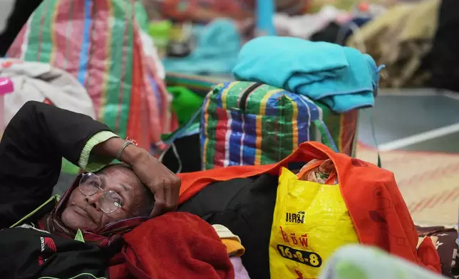 A Thai resident who fled home following the clashes between Thai and Cambodian soldiers, rests at an evacuation center in Surin province, Thailand, Wednesday, Dec. 10, 2025. (AP Photo/Sakchai Lalit)