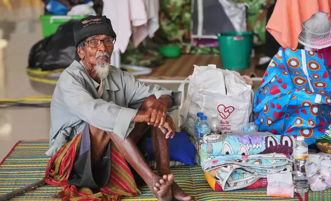 One of Thai residents who fled homes following clashes between Thai and Cambodian soldiers rests at an evacuation center in Surin province, Thailand, Tuesday, Dec. 9, 2025. (AP Photo/Sakchai Lalit)