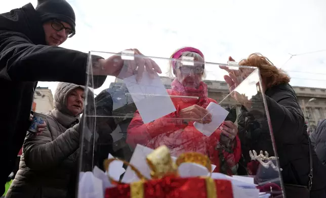Serbia's protesting university students collect signatures for their request for an early parliamentary election, in Belgrade, Serbia, Sunday, Dec. 28, 2025. (AP Photo/Darko Vojinovic)