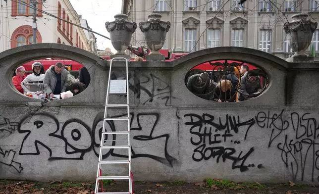 Serbia's protesting university students collect signatures for their request for an early parliamentary election, in Belgrade, Serbia, Sunday, Dec. 28, 2025. (AP Photo/Darko Vojinovic)