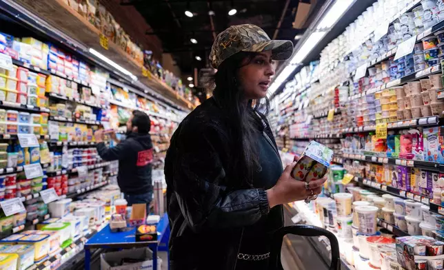 Kashish Ali shops for groceries before filling a One Love Community Fridge, Nov. 15, 2025, in Brooklyn, New York. (AP Photo/Adam Gray)