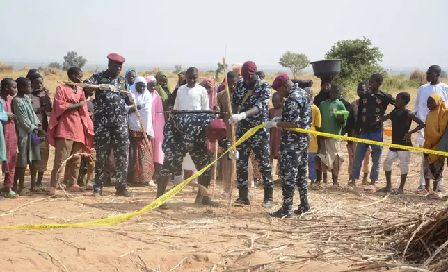 Nigeria police, Anti-Bomb squad, secure the scene of a U.S. airstrike in Northwest, Jabo, Nigeria, Friday, Dec. 26, 2025. (AP Photo/ Tunde Omolehin)