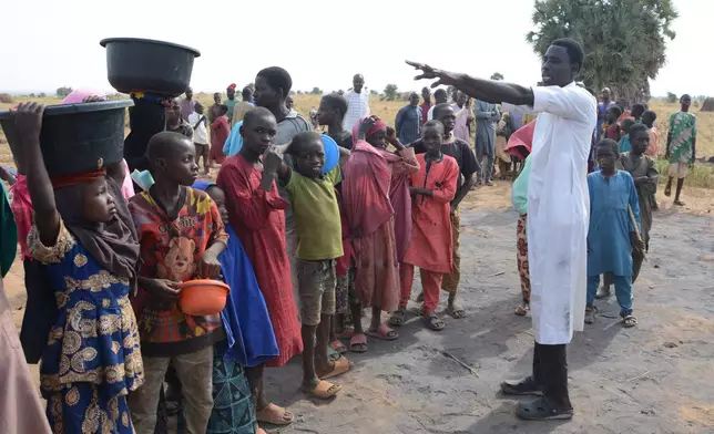 People visit the site of a U.S. airstrike in Northwest, Jabo, Nigeria, Friday, Dec. 26, 2025. (AP Photo/ Tunde Omolehin)