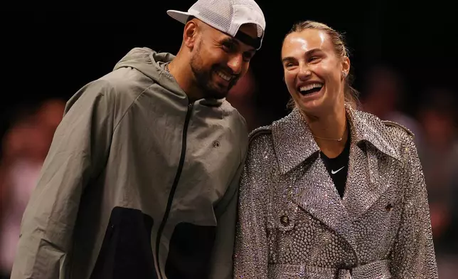 Aryna Sabalenka and Nick Kyrgios laugh ahead of their Battle of the Sexes tennis match in Dubai, United Arab Emirates, Sunday Dec. 28, 2025. (Amr Alfiky/Pool Photo via AP)