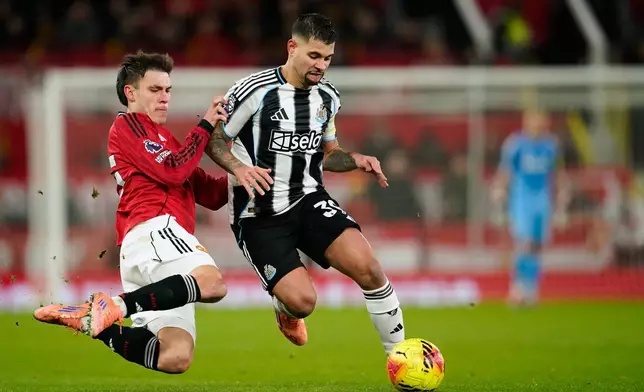 Manchester United's Manuel Ugarte, left, fights for the ball with Newcastle's Bruno Guimaraes during the English Premier League soccer match between Manchester United and Newcastle in Manchester, England, Friday, Dec. 26, 2025. (AP Photo/Dave Thompson)