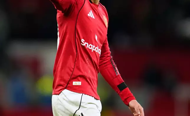 Manchester United's Matheus Cunha celebrates his teams win during the English Premier League soccer match between Manchester United and Newcastle in Manchester, England, Friday, Dec. 26, 2025. (AP Photo/Dave Thompson)