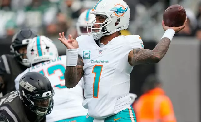 Miami Dolphins quarterback Tua Tagovailoa (1) passes against the New York Jets during the second quarter of an NFL football game, Sunday, Dec. 7, 2025, in East Rutherford, N.J. (AP Photo/Yuki Iwamura)